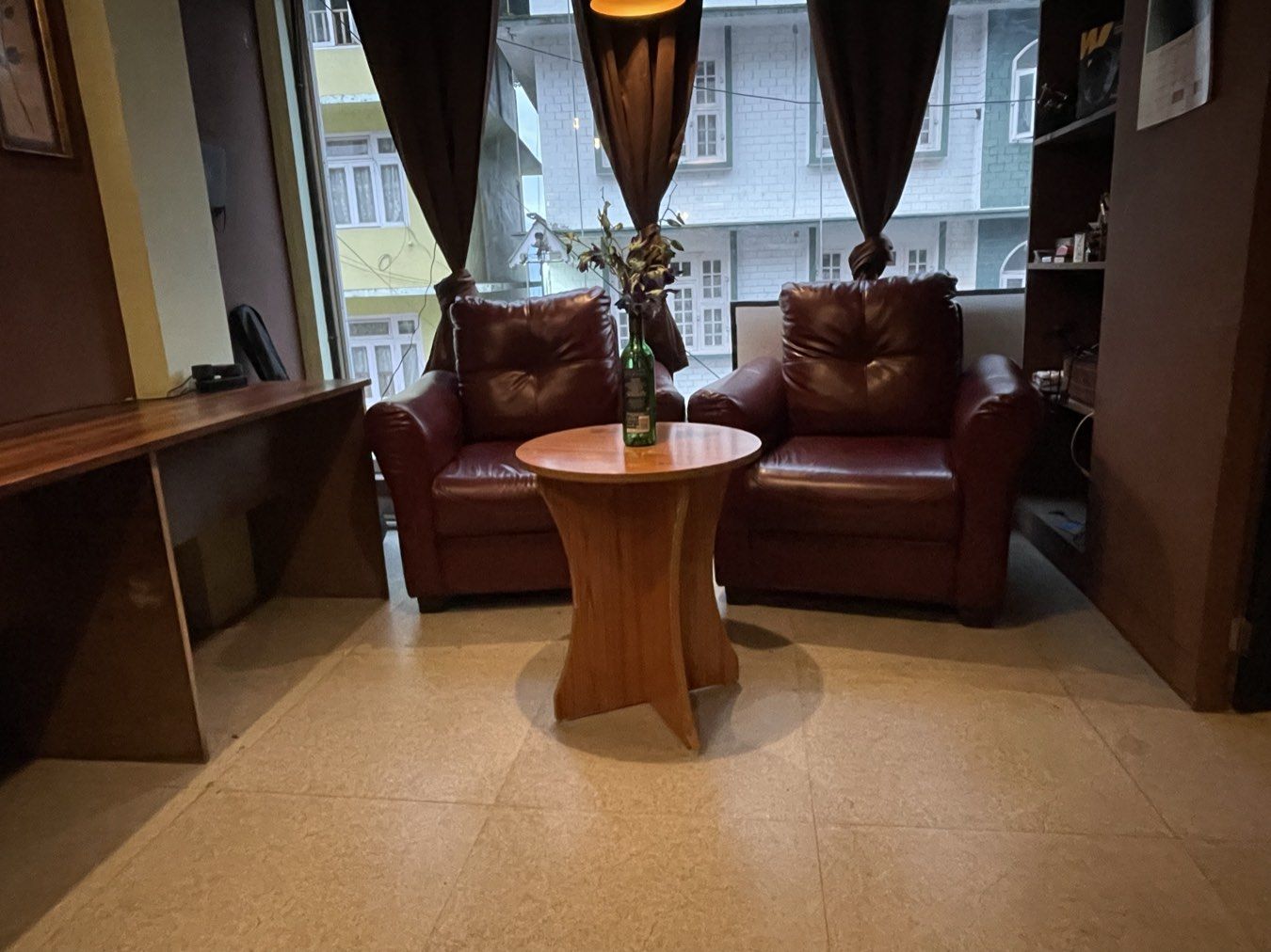 Two armchairs and a side table by the window