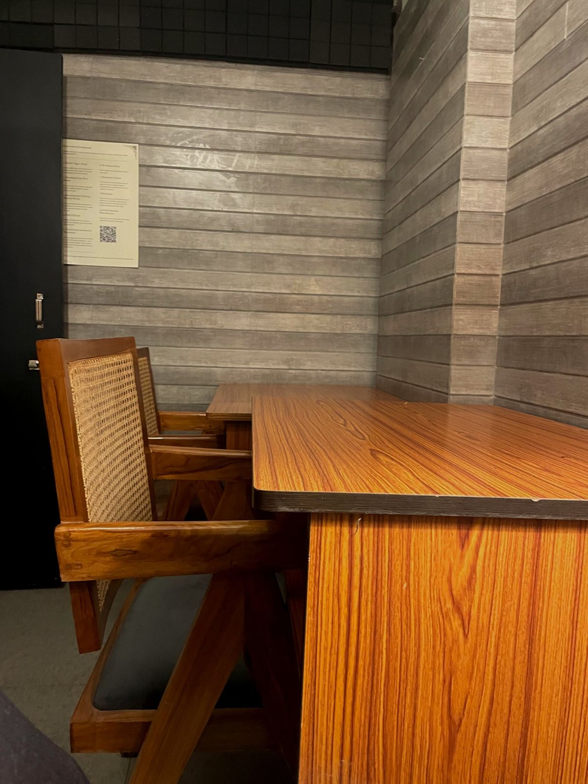 A desk and chair against the panelled wall