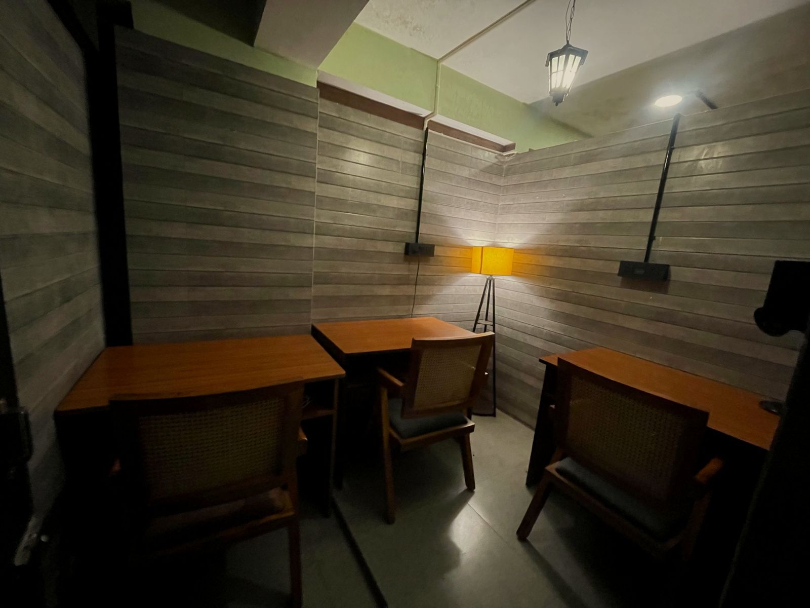 The private pod: three desks, a floor lamp and panelled walls