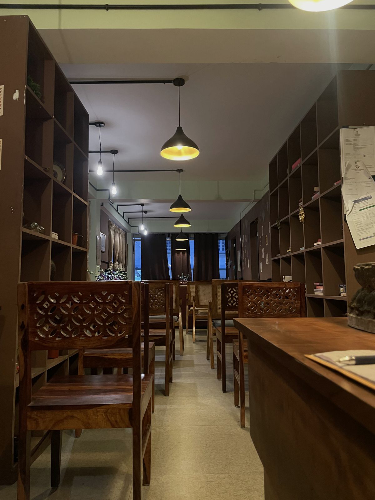 Desks and chairs along the shelving wall